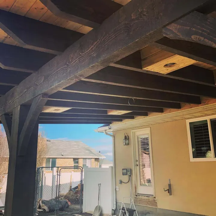 Close view of an attached patio cover post and brace