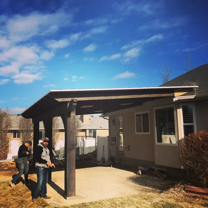 Attached patio cover with people gathered beneath it
