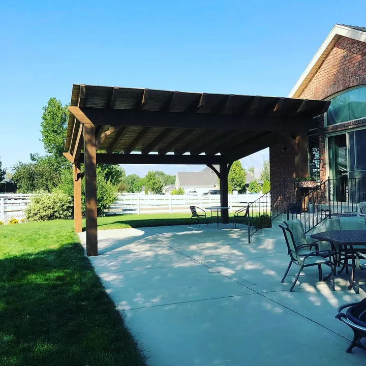 Attached open-lattice pergola over a concrete patio