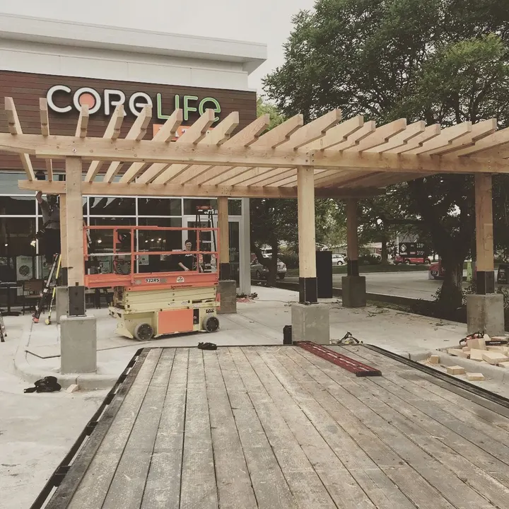 Large pergola under construction at a commercial site