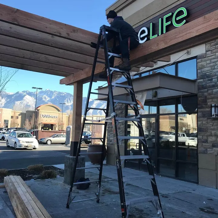Timber pergola installation outside a commercial storefront