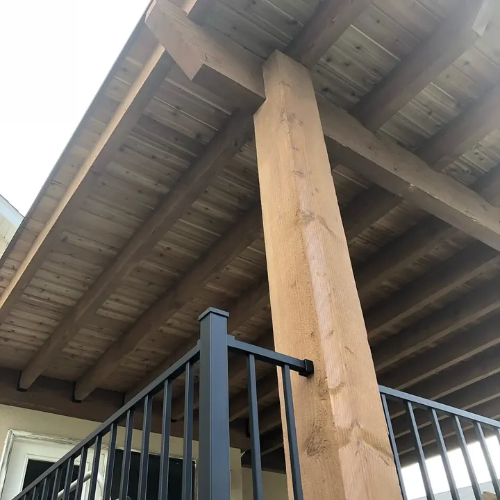 Close view of a covered deck post and roof rafters