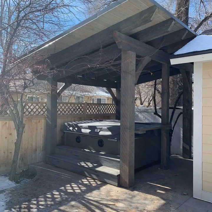 Dark timber pergola covering a hot tub