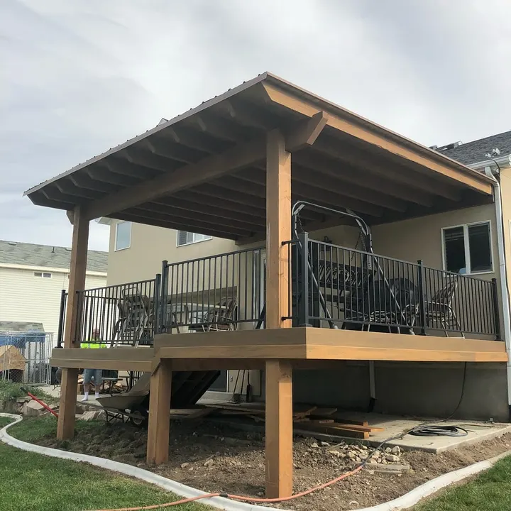 Front view of a covered raised deck with metal railing