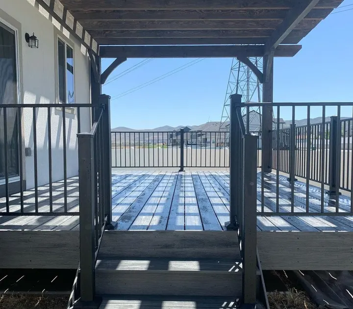 View across a covered raised deck and black railing