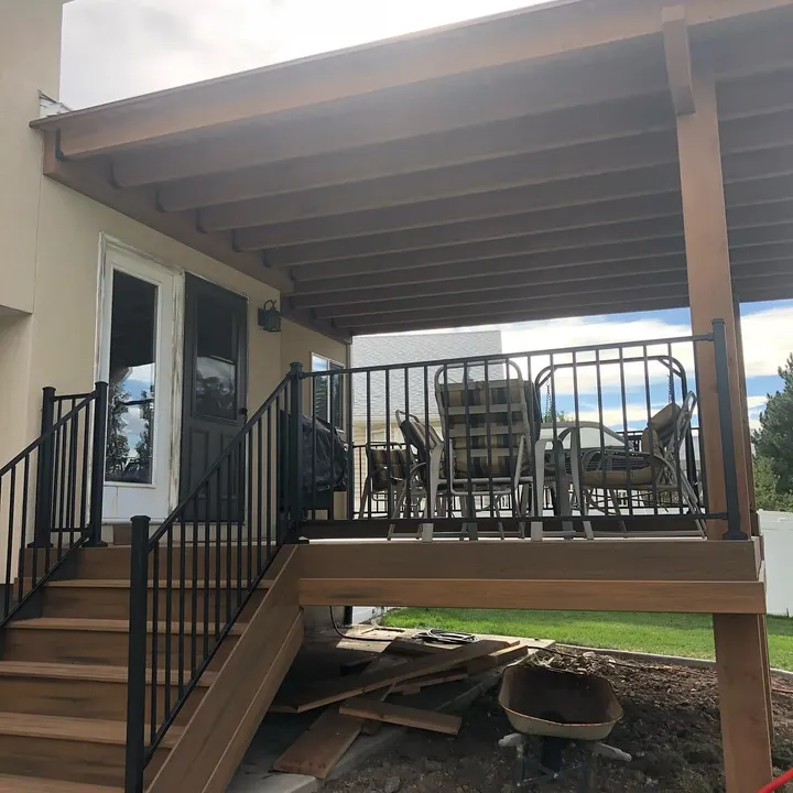 Covered upper deck with black railing and seating