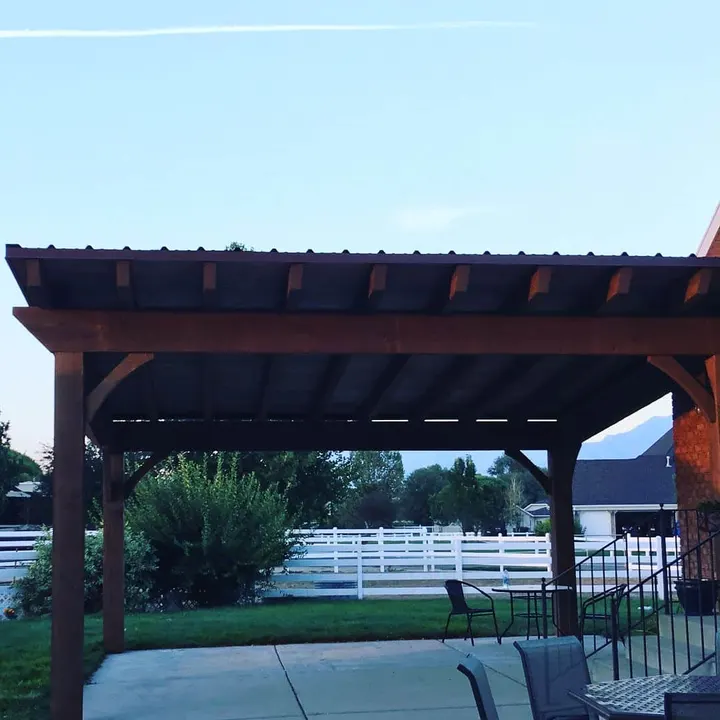 Dark-finished timber cover over a backyard patio