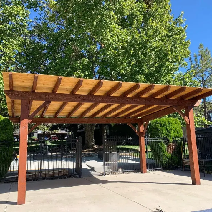 Freestanding open-lattice pergola over a paved patio