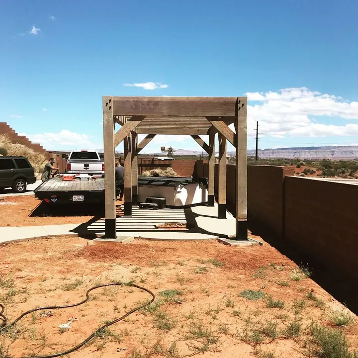 Freestanding open-lattice pergola in an unfinished yard