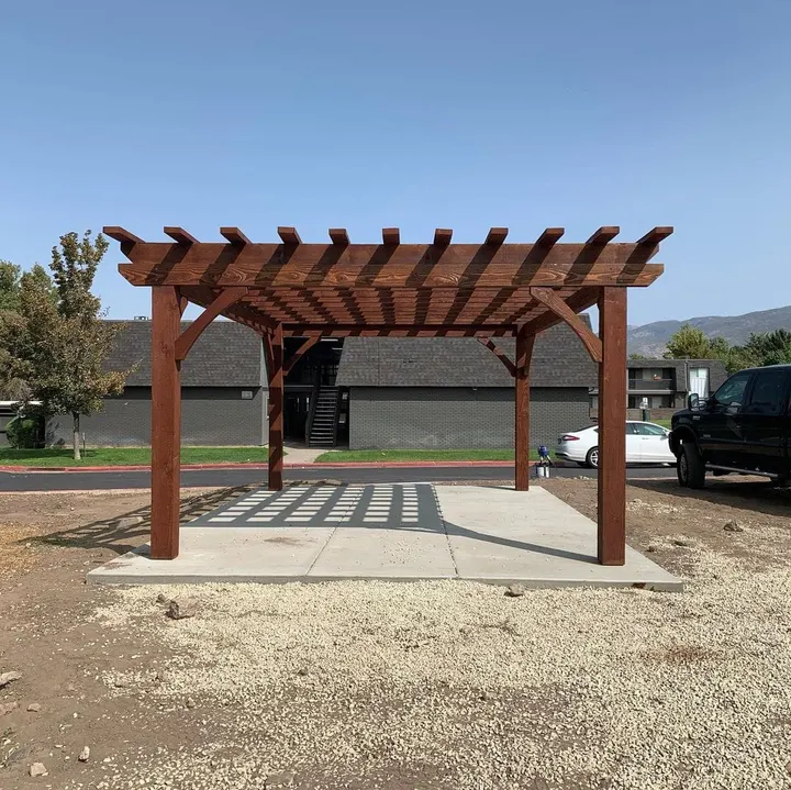 Freestanding open-lattice pergola over a concrete pad