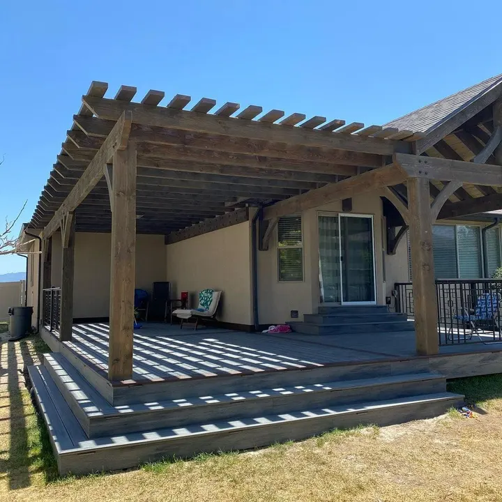 Gabled timber pavilion and open-lattice side section over a deck