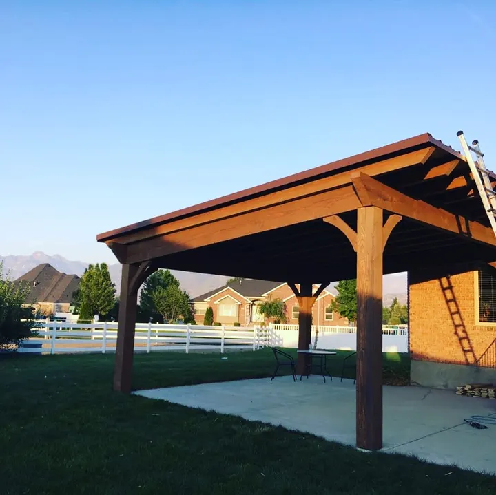 Gabled timber pavilion over a concrete patio