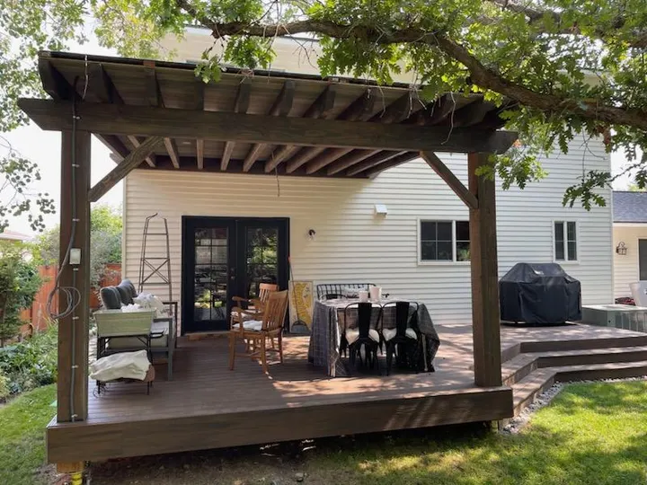 Pergola defining an outdoor dining deck