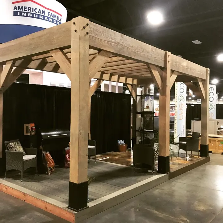 Corner view of a timber structure displayed indoors