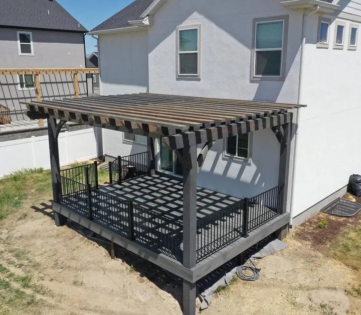 Open-lattice cover over a high deck beside a two-story home