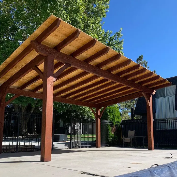 Close view of an open-lattice pergola roof and corner posts