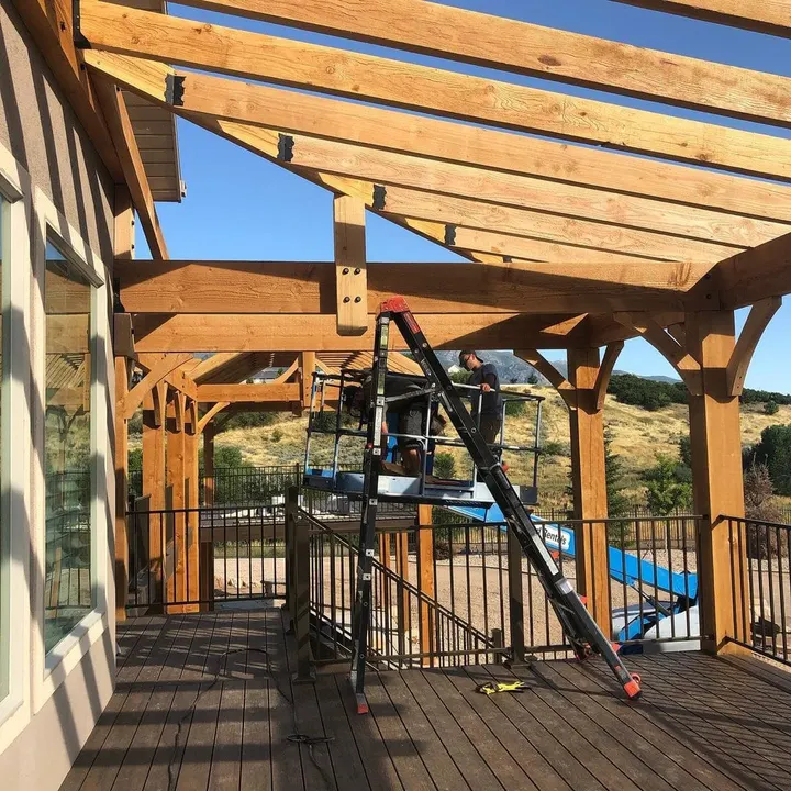 Timber pergola under construction beside a pool