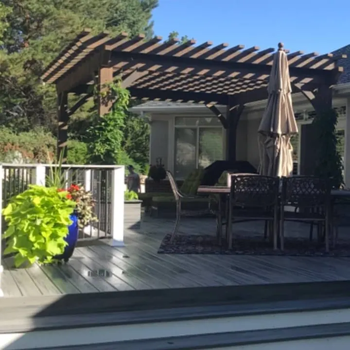 Open-lattice pergola over an outdoor dining deck