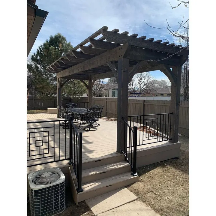 Pergola over a raised deck viewed through the entry gate