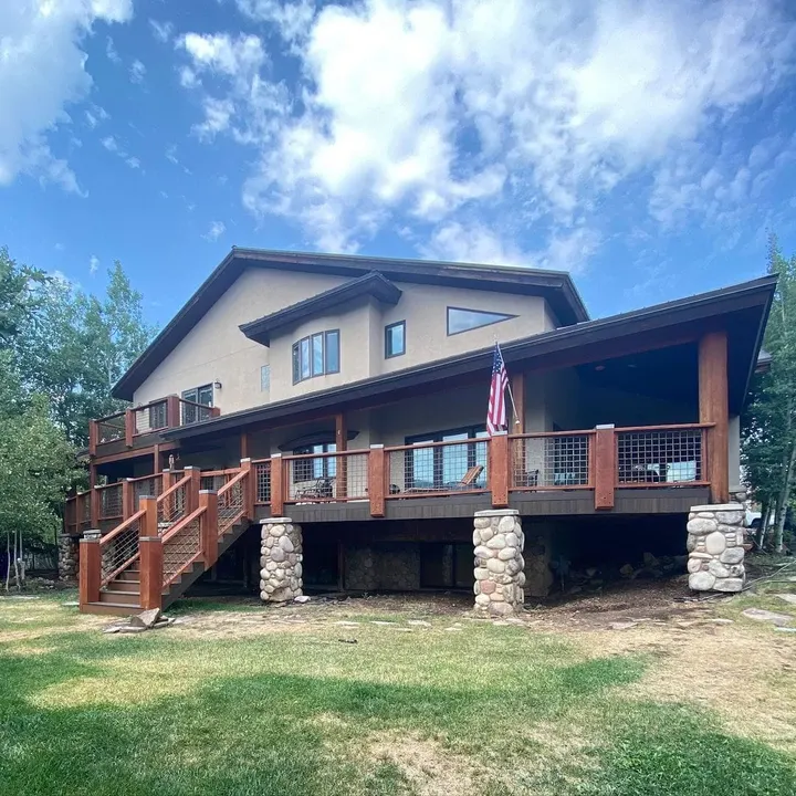 Elevated deck with timber railing and stone support columns