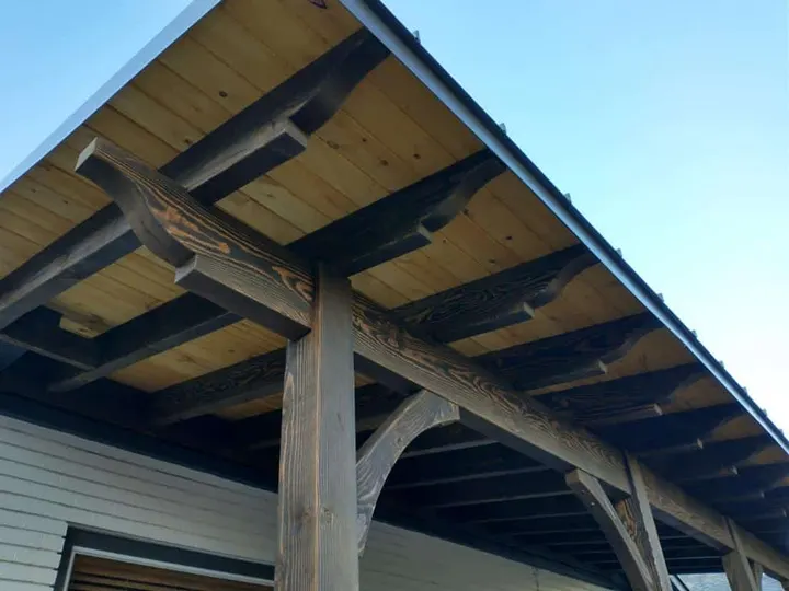 Close view of roof rafters over a deck