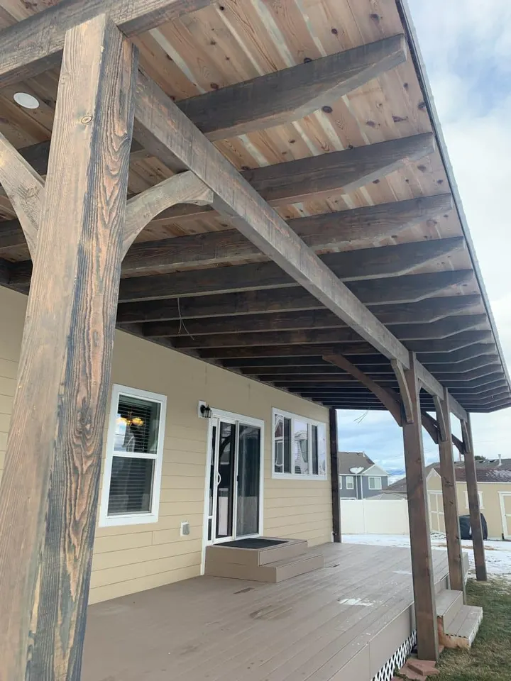 Close view of a rustic post supporting a roofed patio