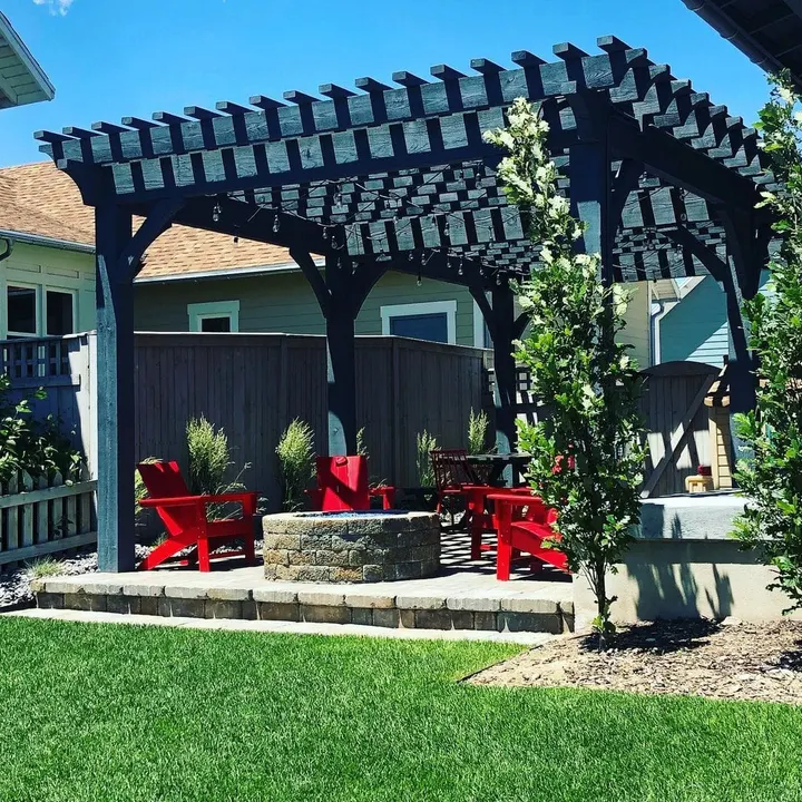 Small garden pergola surrounding red outdoor seating