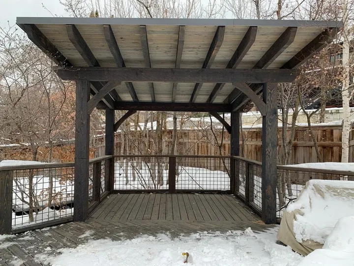 Open-lattice pergola over a snow-covered deck