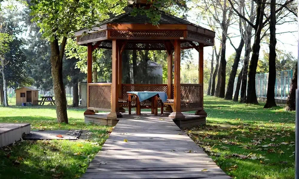Wood gazebo in a landscaped park setting
