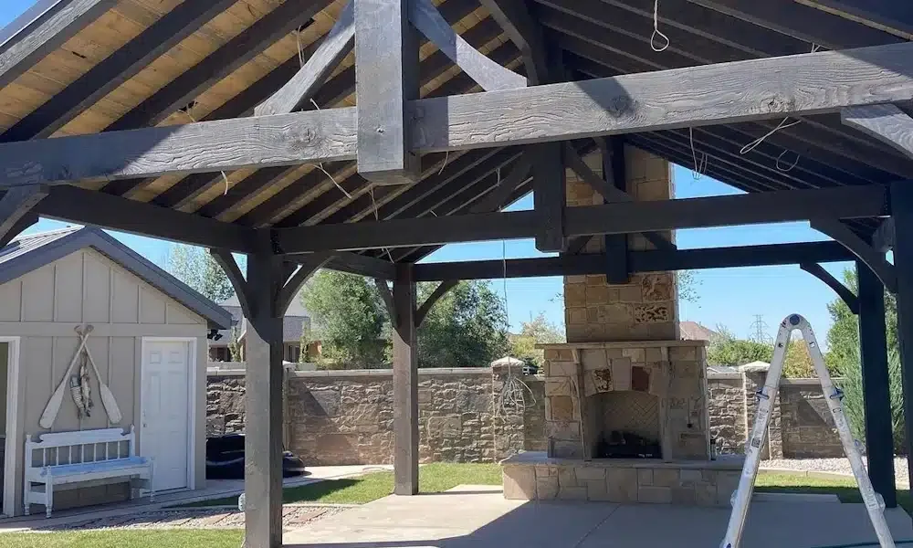 Timber pavilion kit with stone fireplace