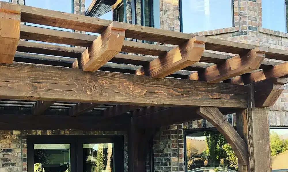 Exposed timber joinery, roof framing, and exterior hardware